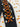 Close up of sleeve with orange metallic lace-up, glittery yellow grommets, white cat ghost designs.