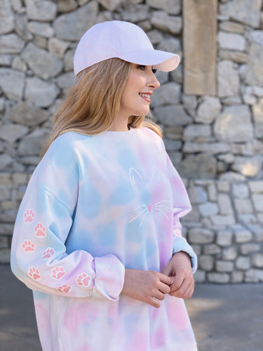 Model wearing pink & blue tie dye cat paw and face crewneck.