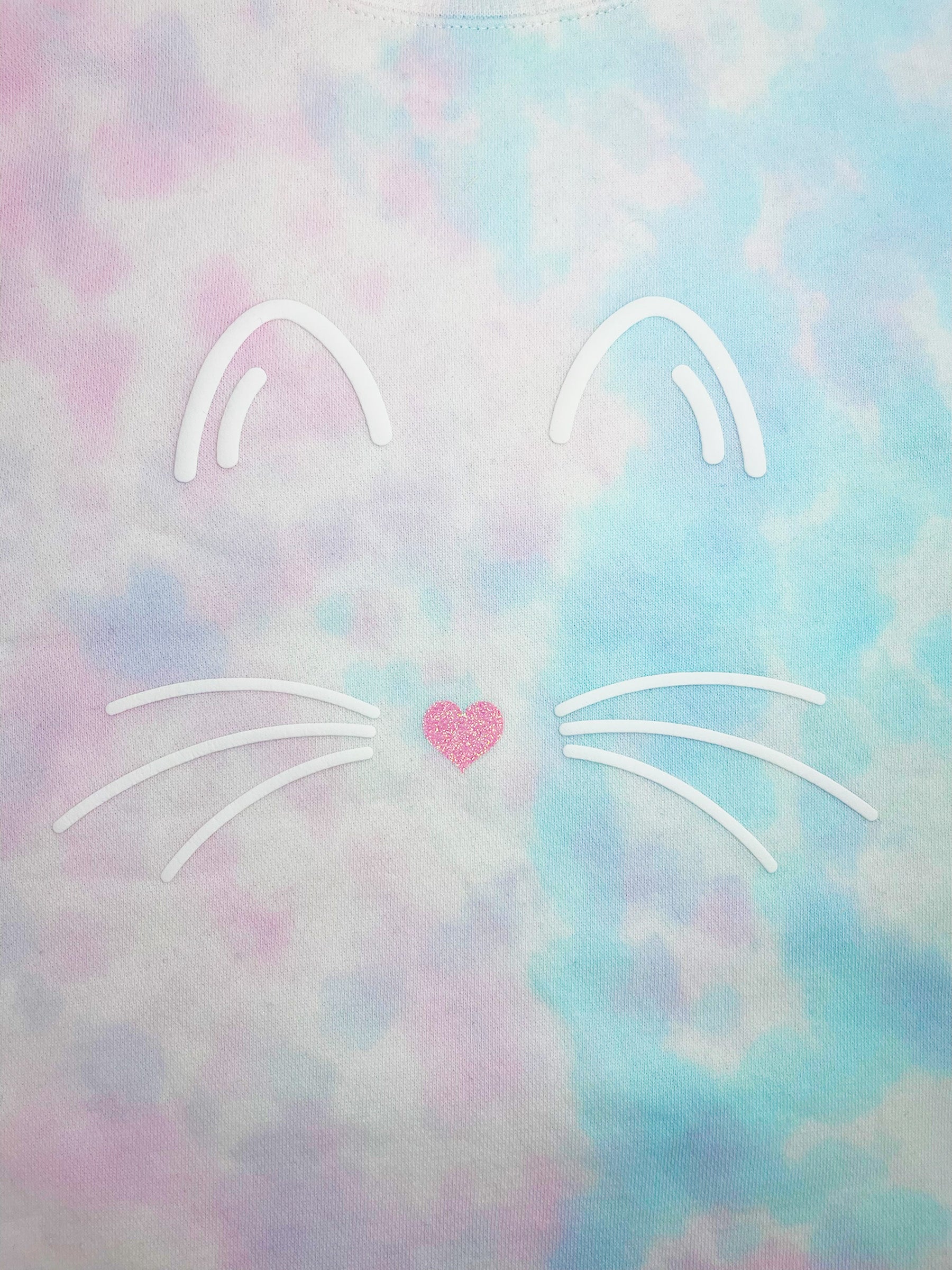 Close up of cat face with white outline of cat ears and wishers with a pink glitter heart nose.