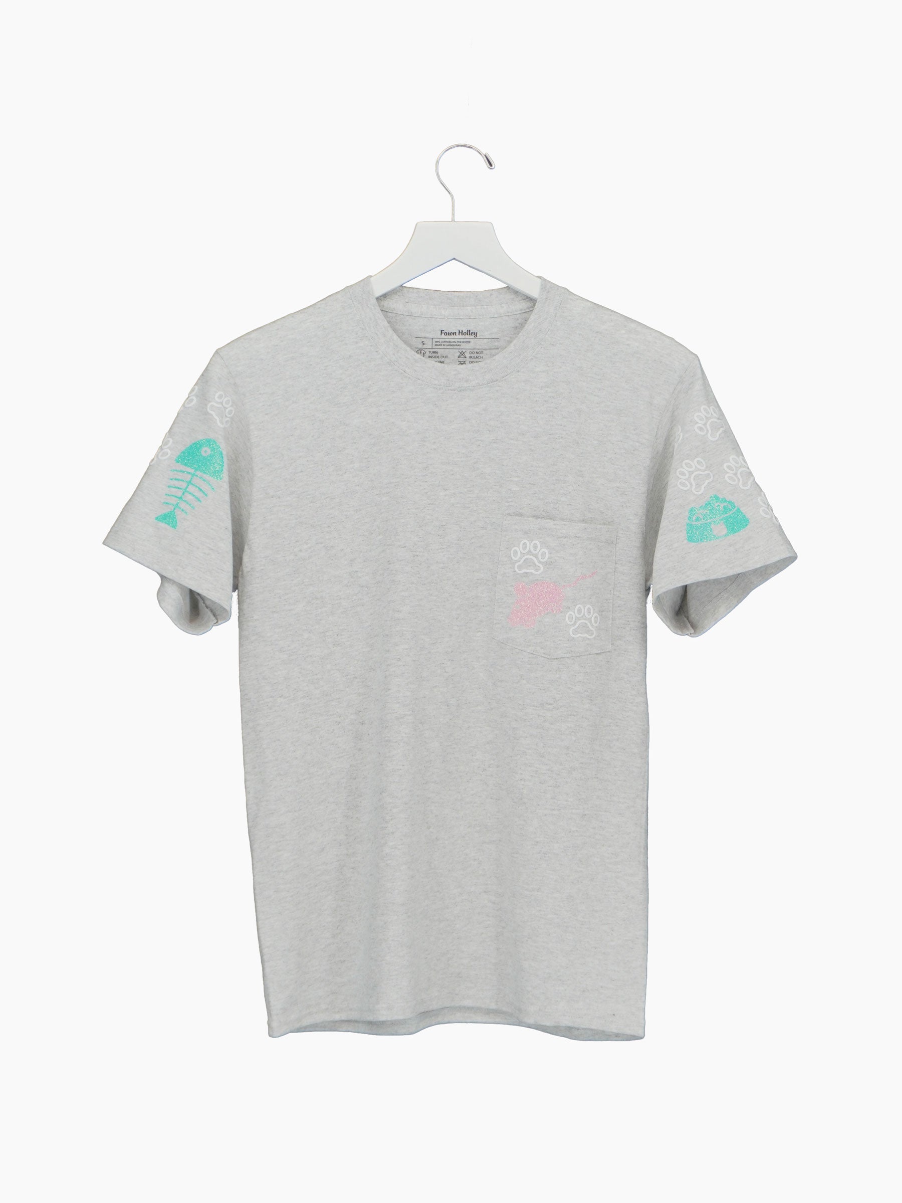 Pocket tee with white cat paws and glittery pink and mint cat related designs on sleeves and pocket.