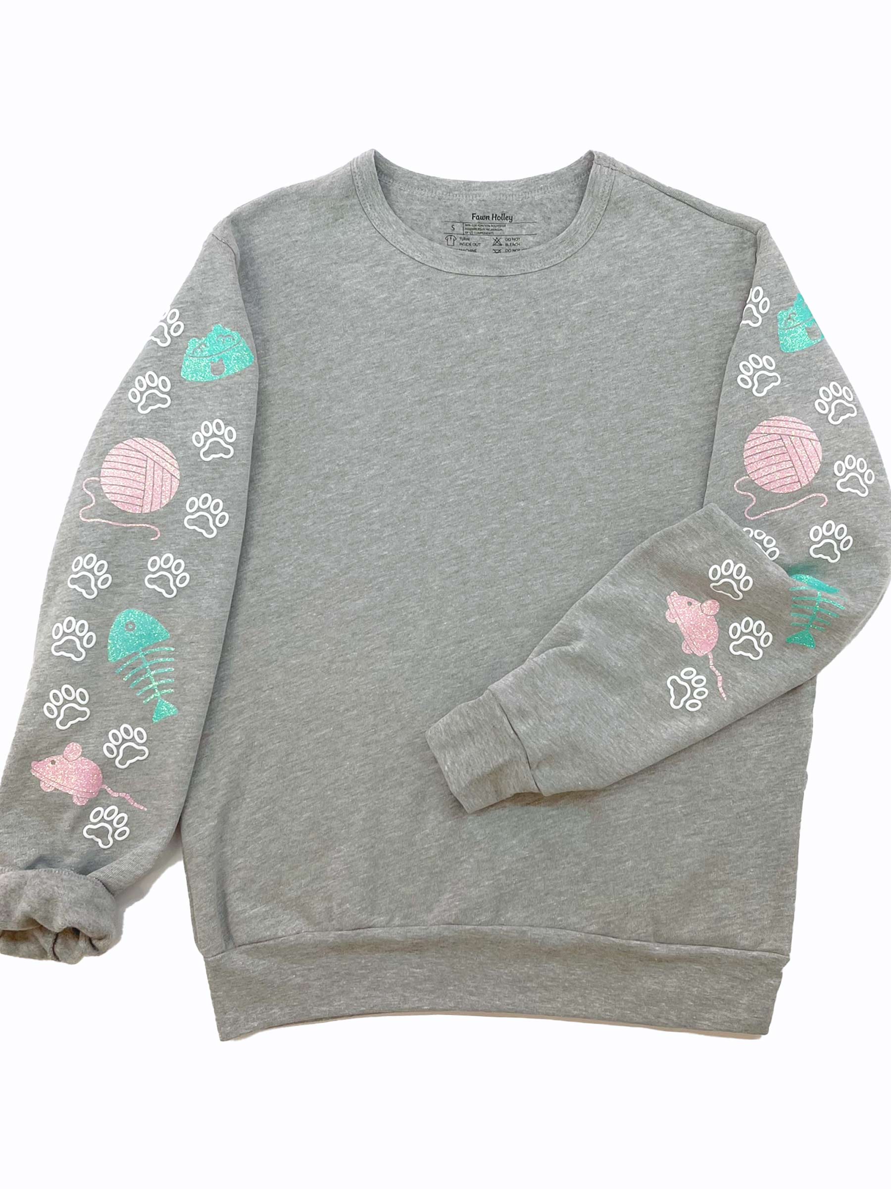 Sleeves with sparkly mouse toy, yarn ball, fish bones and food bowl designs and white cat paws.